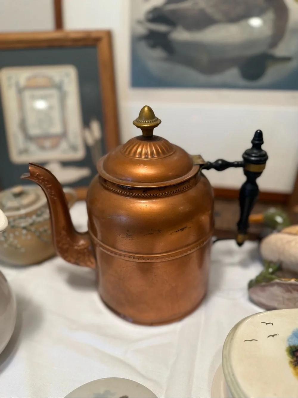 Copper-Color Metal Teapot with Black Handle and Decorative Finial